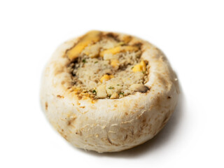 One stuffed mushroom cup on white background. High quality dish for cooking in the oven.