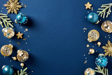 Christmas card. Frame borders made of gold balls, decorations, fir branches on dark blue background. Luxury style.