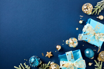 Christmas card with luxury gift boxes, golden ball decorations, fir branches on dark blue...
