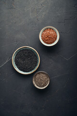 Black sesame, flax and chia seeds in ceramic plates