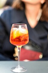a woman sitting behind an ice cream soda with a cocktail in it