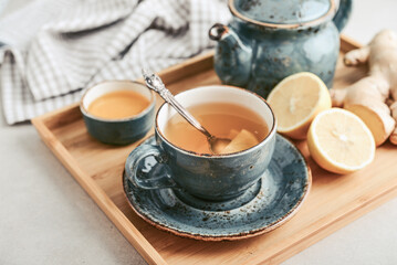 Ginger tea with lemon in a blue cup