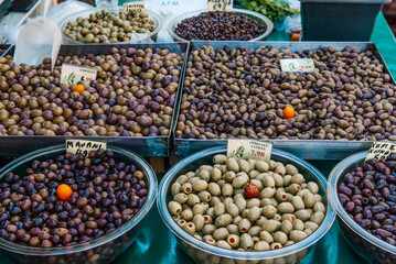 olives in bowls on table at the farmers market in Greece