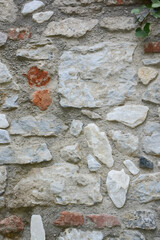 Uneven stones of different shapes in the wall