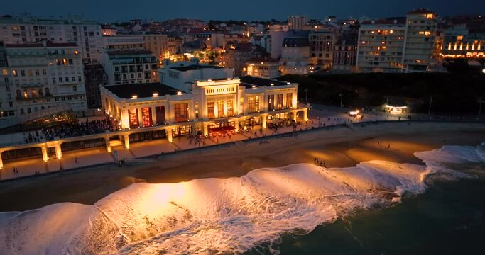 Biarritz large aerial view of the main beach and Biarritz city at night France. View of facade of Hotel Sofitel Biarritz Le Miramar Sea. Everything along the coast is in lights and illumination