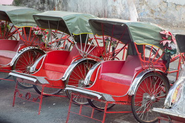 Red Rickshaw Style Bike Taxis with Green Awnings in Penang Malaysia 