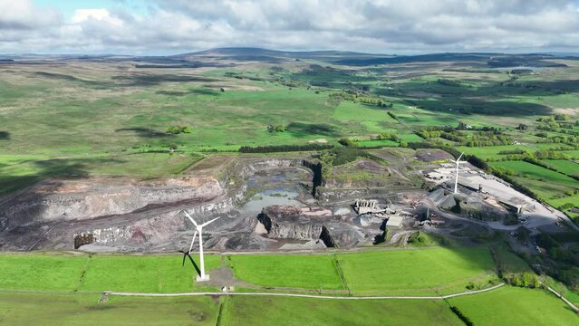 Aerial video of a working Black Stone Quarry with lorries and diggers