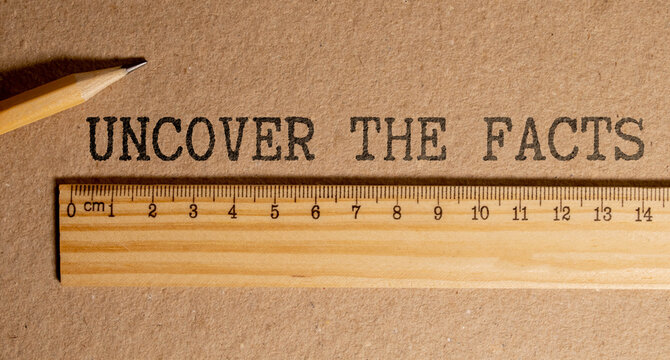 paper with text uncover the facts on white background.
