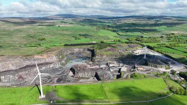 Aerial video of a working Black Stone Quarry with lorries and diggers
