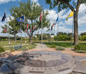 Monument, Plaque and Flags Marking the Geographic Center of the United States in Belle Fourche, South Dakota  - 670766315