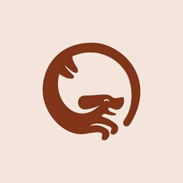 silhouette of a happy and smiling dog chasing its tail logo