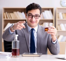 Young businessman drinking from stress