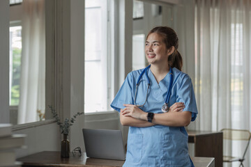 Smiling female doctor wearing a stethoscope in the doctor's office in the hospital