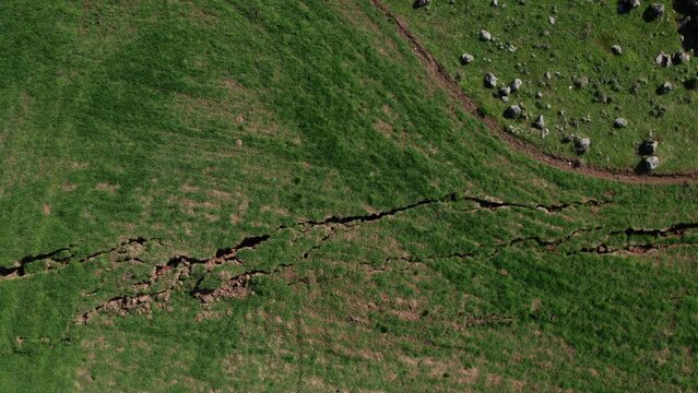 The image of the broken fault line stretching for kilometers of a very large earthquake in the agricultural area.Faults of the earth crust, consequence of the earth.Fault line break.Disaster results.