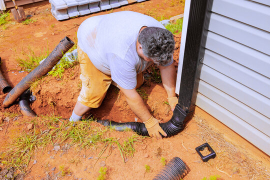 Flexible gutter extension drainage pipe connector downspout installation with water draining down