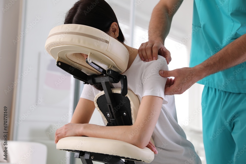 Sticker woman receiving massage in modern chair indoors