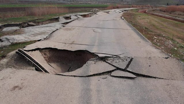 Heavy damage in the earthquakes, some roads became completely unusable. It collapsed due to fragmentation and cracks in the connecting roads.Close-up of ruined road or street with parts of asphalt.
