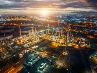 Aerial view of the petrochemical, oil and gas industry. Industrial field, oil refinery storage tanks and steel pipelines at night, ecology and health.	