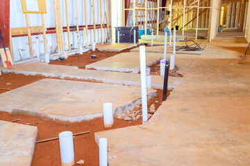 Plumbing preparation pvc pipe endings exposed in concrete floor for future lavatory a restroom