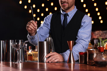 Bartender preparing fresh alcoholic cocktail in bar, closeup