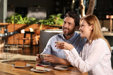 Romantic date. Lovely couple spending time together in cafe, space for text