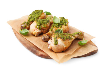 Delicious fried chicken drumsticks with pesto sauce and basil isolated on white