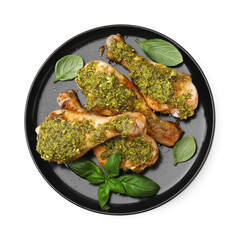 Delicious fried chicken drumsticks with pesto sauce and basil isolated on white, top view