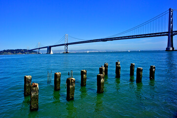 Remnant cement piles and rebar from Old San Francisco pier with the San Francisco Oakland Bay...