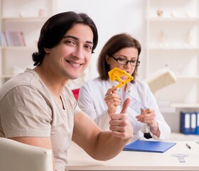 Female doctor checking patient's joint flexibility with goniomet