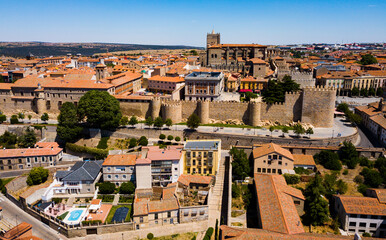 Aerial cityscape of stone defense wall and houses of ancient Avila town in Spain