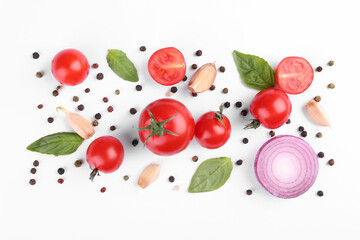 Flat lay composition with different whole and cut tomatoes on white background