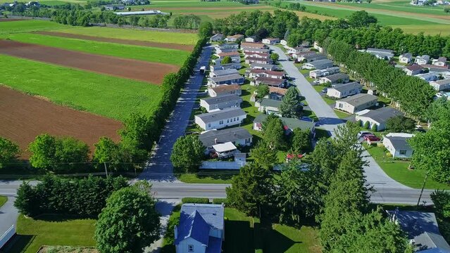Aerial View of a Well Kept Mobile, Manufactured, Prefab Home Park of Single Wide and Double Wide Houses on a Sunny Day