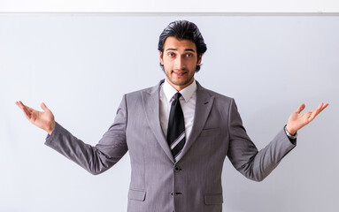 Young handsome businessman in front of whiteboard
