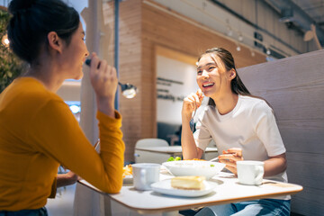 Asian beautiful women having dinner with friend in restaurant together. 