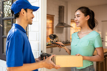 Asian young delivery man delivering package to female customer at home. 