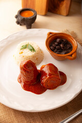 Meat rolls with adobo, stuffed with cheese, vegetables or other ingredients, and served with rice and beans, also called in Mexico as Wrapped Child or meat rolls. Traditional homemade recipe