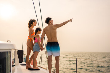 Caucasian happy family walking on deck of yacht while yachting outdoor.  - obrazy, fototapety, plakaty