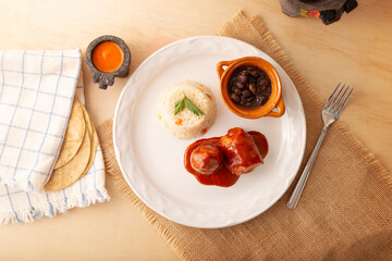 Meat rolls with adobo, stuffed with cheese, vegetables or other ingredients, and served with rice and beans, also called in Mexico as Wrapped Child or meat rolls. Traditional homemade recipe