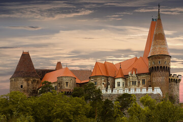 Impressive twilight landscape with medieval Corvin Castle on elevated rock, Hunedoara, Romania