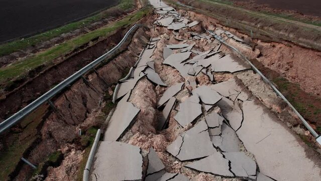Heavy damage in the earthquakes, some roads became completely unusable. It collapsed due to fragmentation and cracks in the connecting roads.Close-up of ruined road or street with parts of asphalt.