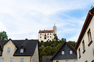 Obraz premium Hilltop castle in Gößweinstein in the Franconian Switzerland. The medieval building is located above the town. The old landmark is a popular travel destination in the region.