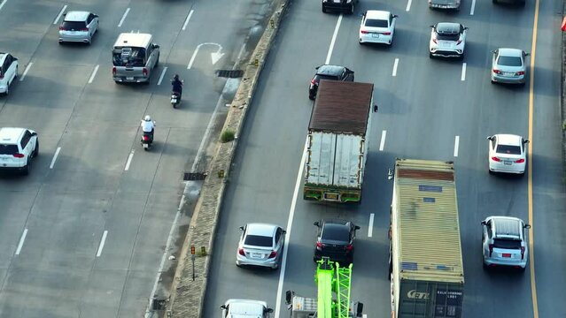 From the above, the motorway resembles a chaotic battlefield during rush hour, with vehicles locked in a fierce struggle for inches of progress. Time Loss: Delays in travel. Traffic concept. 4K.
