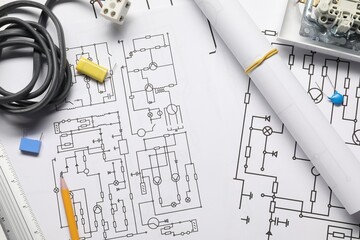 Wires and office stationery on wiring diagrams, top view