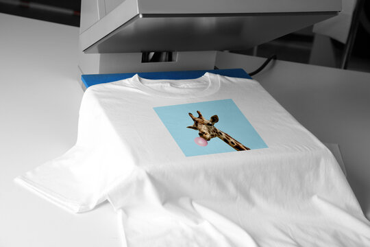 Custom t-shirt. Using heat press to print image of giraffe blowing bubble gum