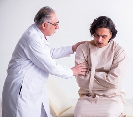 Aged male doctor psychiatrist examining young patient
