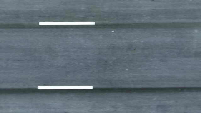 Aerial drone view : Experience the awe-inspiring marvel of a groundbreaking intercity motorway, devoid of cars, as seen from a drone's perspective. A futuristic vision of urban connectivity. 4K HDR.
