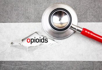 OPIOIDS text, inscription with stethoscope. Opioids, medical concept.