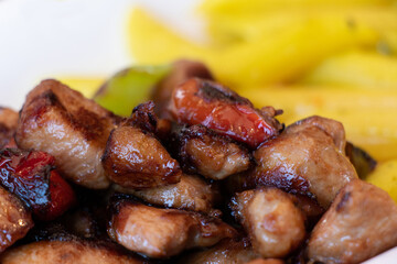 Spicy chicken fillet bites with tomato. Food photography
