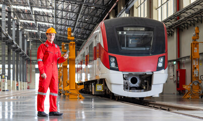 Electric train technician engineer checking controls system for security functions in maintenance infrastructure plant of sky train, public transportation vehicle,Teamwork management concept.