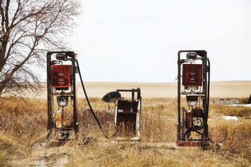 Two abandoned vintage gas pumps